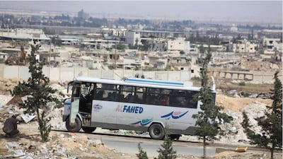 A bus carrying Jaish Al Islam rebel fighters and their families out of the Eastern Ghouta town of Douma arrives at the Wafideen crossing on April 14, 2018. AFP