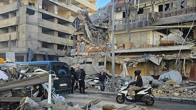 People stand amid the debris of a destroyed building following airstrikes in Beirut’s southern suburbs of Ghobeiry neighborhood, on March 5, 2026. Israel said it carried out strikes on Beirut targeting Iran-backed militant group Hezbollah on March 5, while Lebanese state media reported an Israeli drone strike killed a Hamas official. (Photo by AFP)
