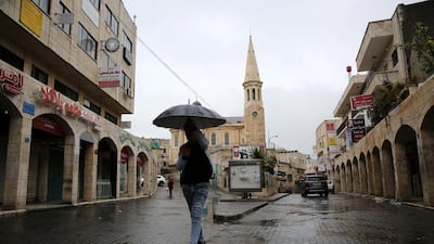 A man walks past closed shops in West Bank city of Bethlehem on March 6, 2020. EPA