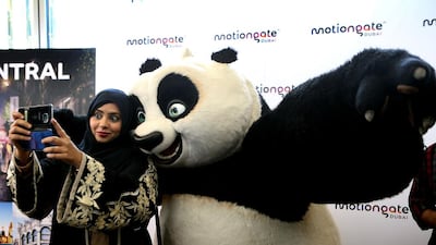 Shaikha al Shamsi, head of destination and marketing at Dubai Parks and Resorts takes a selfie with Panda during a press conference at Reel Cinemas in Dubai. Ravindranath K / The National