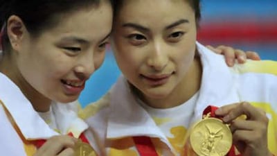 Guo Jingjing, right, and Wu Minxia of China display their gold medals after winning gold in the women's synchronized 3-metre springboard diving.