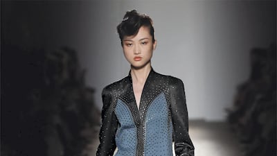 Model Jing Wen carries Model the classic Lauren 1980 clutch in black, at the Bottega Veneta autumn/winter 2017 fashion show in Milan