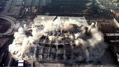 The Seattle Kingdome, home of the Seattle Seahawks American football team, implodes on March 26, 2000, in Seattle, Washington. AFP