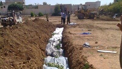 Some of the hundreds of civilian men, women and children who died in a bloody door-to-door killing spree by government forces were buried in this mass grave in Daraya.