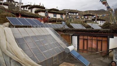 Solar panels are installed on the rooftop of a traditional house in the mountain village of Demul. Thomas Cytrynowicz / AP Photo