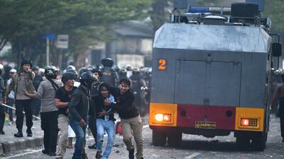 Police detain protesters after clashes in Jakarta, Indonesia. Reuters