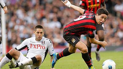Samir Nasri, right, keeps his balance and evades a slide tackle from Clint Dempsey as Manchester City lose their 100 per cent record with a 2-2 draw at Fulham. Sang Tan / AP Photo