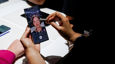 People test new phones. Reuters