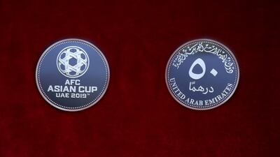 The commemorative silver coin features the Asian Cup logo.
