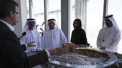 Rob Lloyd, chief executive of Hyperloop One, left, shows a model of the transport system to Mattar Al Tayer, director general of the RTA, in Dubai. AP Photo
