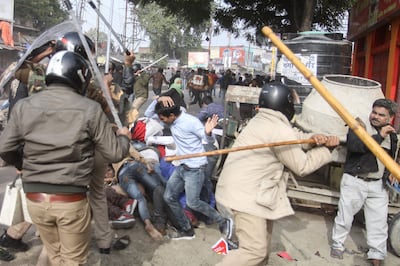 Police beat protesters with sticks during a demonstration against India's new citizenship law in Lucknow. AFP