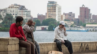 People sit on the bank of River Nile during a cloudy morning in Cairo, Egypt. EPA