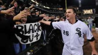 The Chicago White Sox's Jim Thome celebrates with fans after the battling 1-0 win over the Minnesota Twins in the American League Central tiebreaker game.