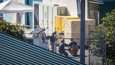 Investigators gather evidence at the scene of the mass shooting. AFP