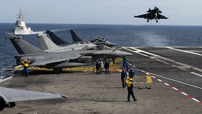 A Rafale fighter jet lands on France's Charles de Gaulle aircraft carrier in February 2019. AFP