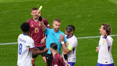 Kylian Mbappe of France pleads with the referee as Aurelien Tchouameni of France is shown the yellow card. AP
