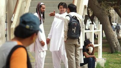 Potential passengers look for a ride near the pedestrian bridge on Muroor Road across from the main bus terminal, by Al Wahda Mall. Delores Johnson / The National