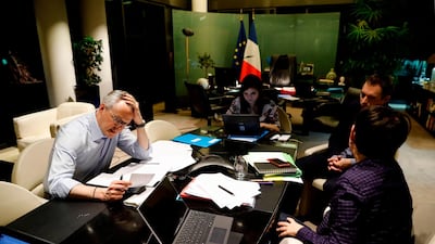 French Economy and Finance Minister Bruno Le Maire (L) speaks on the phone with his German counterpart as his advisor Juliette Oury (C), his cabinet director Emmanuel Moulin (2nd R) and French Treasury director Odile Renaud-Basso attend, during a break in a videoconference meeting of the Eurogroup of eurozone finance ministers to discuss coronavirus response on April 7, 2020 at the French Economy ministry in Paris AFP