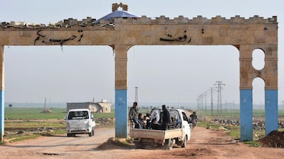 Civilians fleeing the city of Afrin in northern Syria are seen on the back of a pick up truck as they enter the village of Tal Rifaat in the government-controlled part of the northern Aleppo province, on March 18, 2018. George Ourfalian / AFP