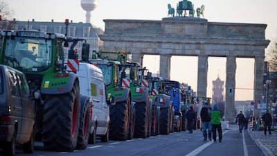 Tractors block the western road to Berlin's Brandenburg Gate on Monday at the start of a week-long protest against tax rises affecting farmers. AP