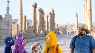 Grover, Basma, Ma'zooza and Jad with Rami Delshad, who portrays Hadi in "Welcome Sesame," a new, locally produced Arabic TV program for the hundreds of thousands of children dealing with displacement in Syria, Iraq, Jordan and Lebanon. (Sesame Workshop via AP)