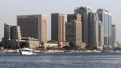 A boat travels along in front of the hotels, banks and office buildings on the Nile River in Cairo, Egypt. Reuters