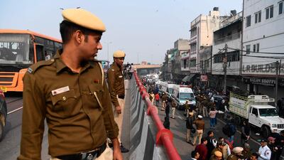 Police personnel stand guard along a flyoner road to prevent onlookers from gathering following a factory fire in Anaj Mandi area of New Delhi. At least 43 people have died in a factory fire in India's capital New Delhi. AFP