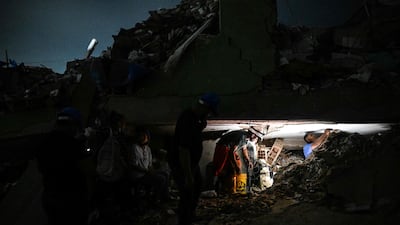 Rescue volunteers take part in the search for bodies amid the rubble 46 days after the 7. 2 and 7. 5-magnitude earthquakes in La Guaira, Venezuela. AFP