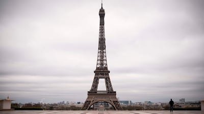 A man walks on the deserted Trocadero square in front of the Eiffel Tower in Paris on the fifth day of a strict nationwide lockdown. AFP