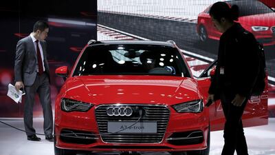 Attendees look at an Audi AG A3 e-tron electric vehicle on display at the 43rd Tokyo Motor Show 2013 in Tokyo, Japan, in November 2013. Bloomberg