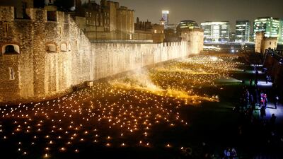 The moat of the Tower of London is seen filled with thousands of lit torches as part of the installation 'Beyond the Deepening Shadow', in London. Reuters