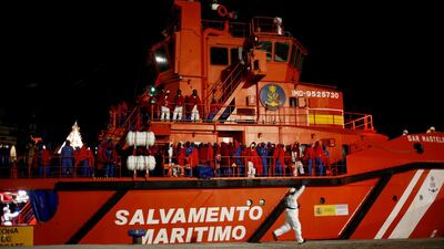 Migrants, intercepted off the coast in the Mediterranean Sea, wait to disembark from a rescue boat at dawn at the port of Malaga, southern Spain. REUTERS