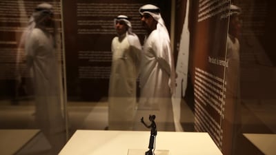 A bronze statuette of a man holding a bird, from the ancient site of Mleiah in Sharjah and on show at the Archaeology Museum. Pawan Singh / The National