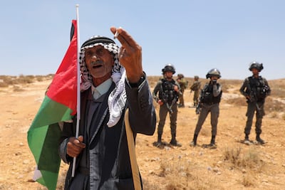 A Palestinian in front of Israeli soldiers in the occupied West Bank. AFP
