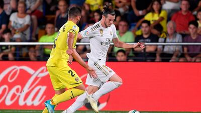 Villarreal's Spanish defender Mario Gaspar (L) challenges Real Madrid's Welsh forward Gareth Bale during the Spanish league football match Villarreal CF against Real Madrid CF at La Ceramica stadium in Vila-real. AFP