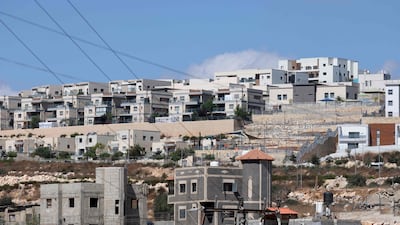 An Israeli settlement looms over Palestinian homes in the village of Bruqin, in the occupied West Bank. AFP