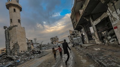 Residents walk past the destroyed Al Mahata mosque and nearby buildings in the Al Tuffah neighbourhood, east of Gaza city, near the ceasefire line between Israel and Hamas. EPA