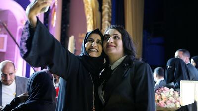 A guest takes a selfie with Khalifa Award for Education winner Ghania Al Banna, right, of Applied Technology High School in Abu Dhabi, after the award ceremony held at Emirates Palace. Pawan Singh / The National