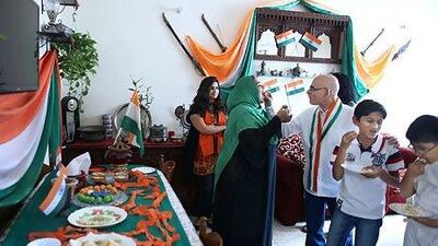 Andaleeb Fatma Mannan (sporting a green head scarf) with her family and friends at her Abu Dhabi home. Delores Johnson / The National