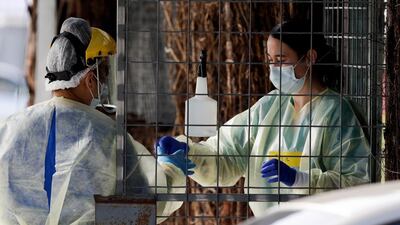 Medical staff prepare to take a Covid-19 tests at a drive-through centre in Christchurch, New Zealand. AP Photo
