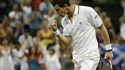 Andy Murray celebrates clinching victory over Stanislas Wawrinka in the fourth-round on Monday evening.