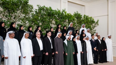 Sheikh Mohamed (front row, fifth left); Sheikh Hamdan bin Zayed (front row, sixth left); Minister of Education Sarah Al Amiri (front row, second right); and Sheikh Khaled bin Mohamed, Crown Prince of Abu Dhabi (top row, second right), stand for a photograph with pupils, parents, teachers and ministry staff. Abdulla Al Bedwawi / UAE Presidential Court