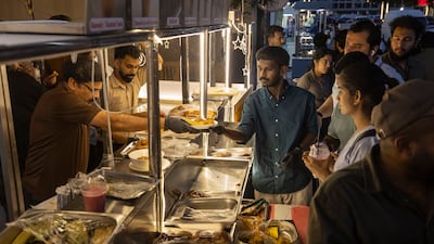 Residents get food from one of the stalls