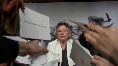 Director Roman Polanski signs autographs during a press conference for Venus in Fur at the 66th international film festival. Virginia Mayo / AP Photo
