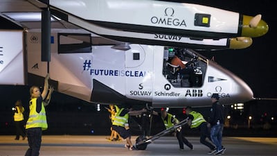 Crew members push Solar Impulse 2 to its take-off position at Nagoya airport. The team says the aircraft faces a long stay in Japan if weather over the Pacific Ocean does not improve soon. Thomas Peter / Reuters
