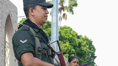 A Sri Lankan Army soldier stands guard outside the St. Theresa's church as the Catholic churches hold services again after the Easter attacks in Colombo on May 12, 2019. AFP / LAKRUWAN WANNIARACHCHI