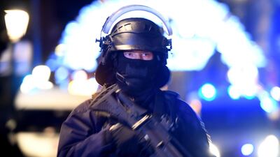 A police officer stands guard near the Christmas market. EPA