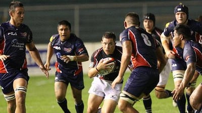 The UAE's Gareth Armstrong tries to advance the ball against the Philippines Volcanoes in their Asian Five Nations closer at Manila on Saturday night.