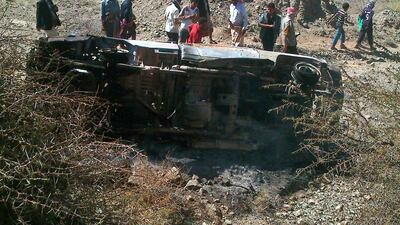 Yemenis stand around a pickup truck after it was allegedly hit by a US drone in Al Bayda province, Yemen on April 19. EPA