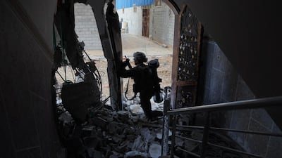 An Israeli soldier stands in a bombed-out building in the northern Gaza Strip. AFP / Israeli Army
